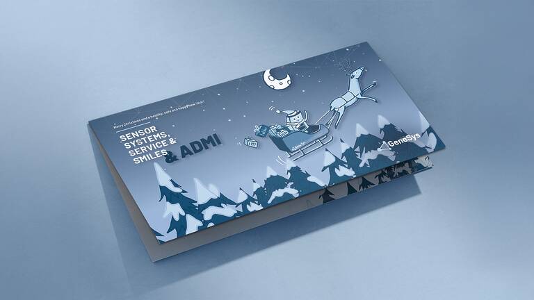 Christmas card with the inscription Sensor Systems, Service & Smiles & Admi. On the front is a sleigh being pulled by a reindeer. In the sleigh sits the GeneSys mascot ADMI and presents with various inscriptions tumble out of the sleigh: gPTP, LatDev and DELTA.